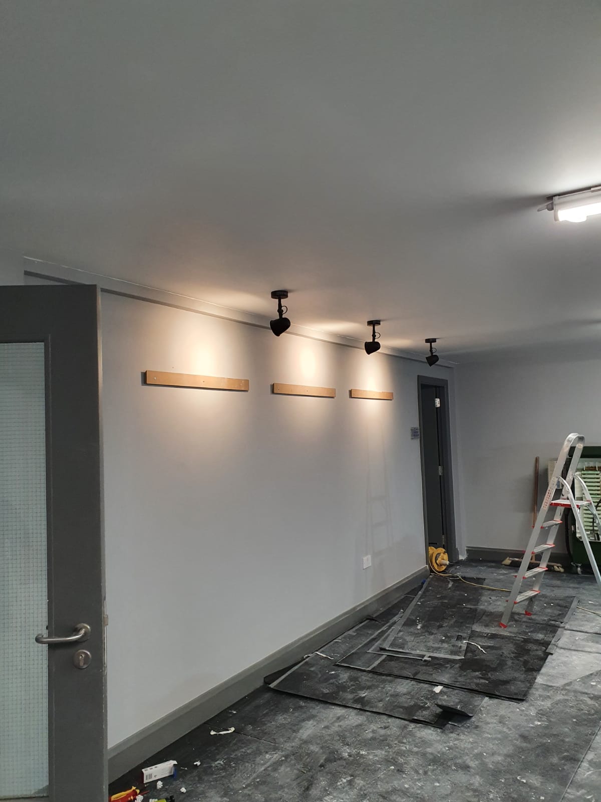 Track lighting being fitted in a room